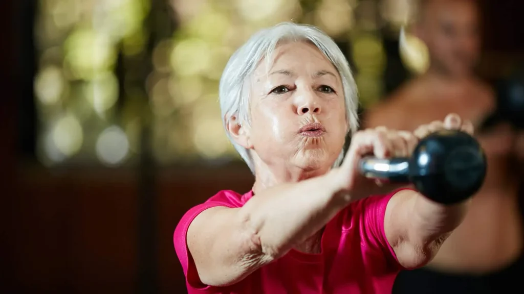 Toning Arms Without the Bulk: Is It Achievable? 1 Woman doing resistance band exercises for toned arms Herne Bay